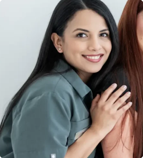 mujeres con ropa de dentista posando y sonriendo para la camara